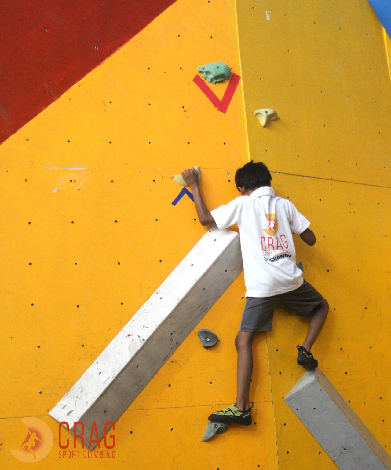 Climbing hold,Climbing,Sport climbing,Bouldering,Rock climbing,Adventure,Yellow,Wall,Recreation,Climbing shoe