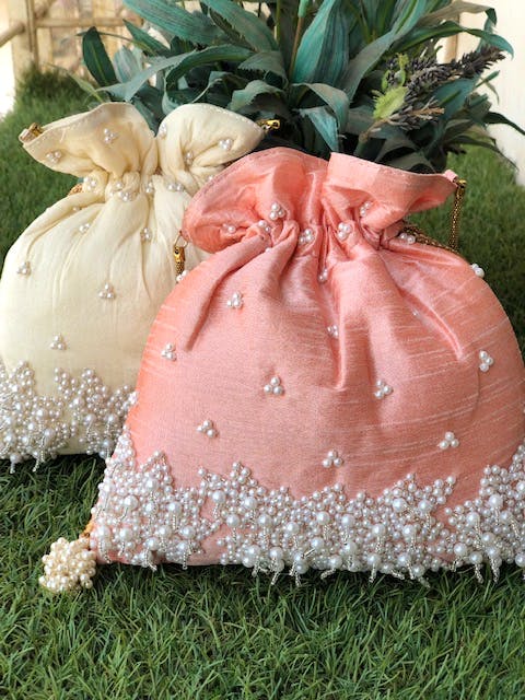 Pink,Wedding ceremony supply,Grass,Dress,Textile,Fashion accessory,Plant,Peach,Flower,Lace
