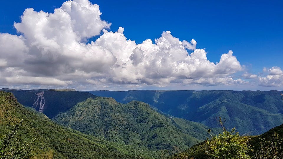 Mountainous landforms,Sky,Mountain,Cloud,Highland,Nature,Natural landscape,Cumulus,Mountain range,Ridge