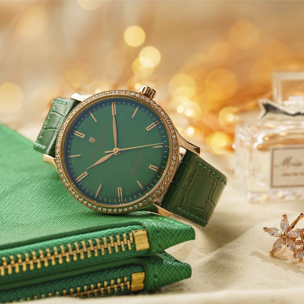 Analog watch,Green,Watch,Watch accessory,Fashion accessory,Jewellery,Wrist,Material property,Font,Quartz clock