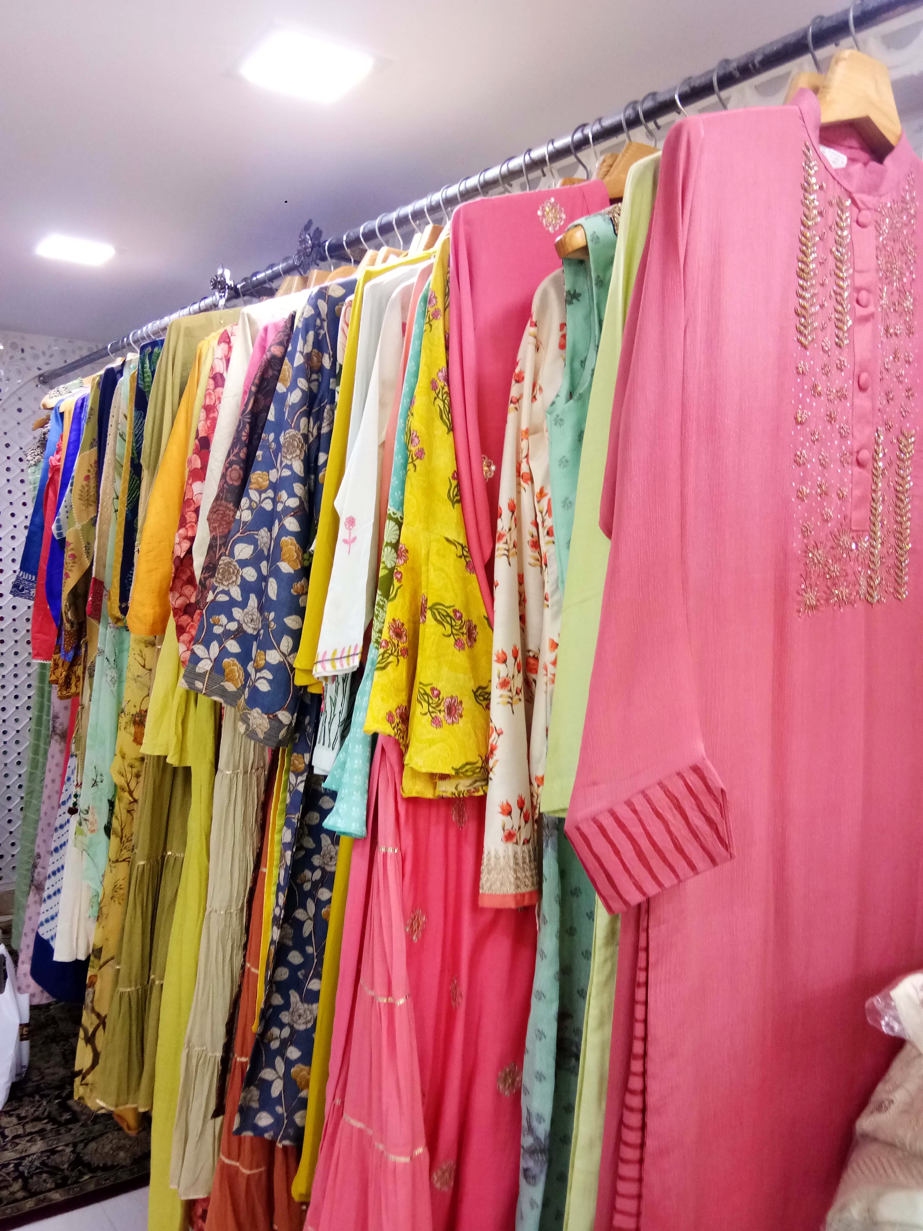 Clothing,Boutique,Room,Pink,Textile,Clothes hanger,Furniture,Dress,Magenta,Closet