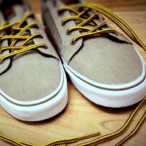 Footwear,Shoe,Sneakers,Skate shoe,Plimsoll shoe,Yellow,Athletic shoe,Walking shoe