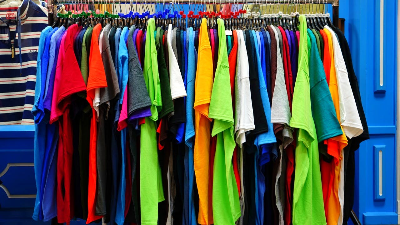 Clothing,Clothes hanger,Room,Textile,Dress,Closet,Sportswear,Fashion accessory,Boutique,T-shirt