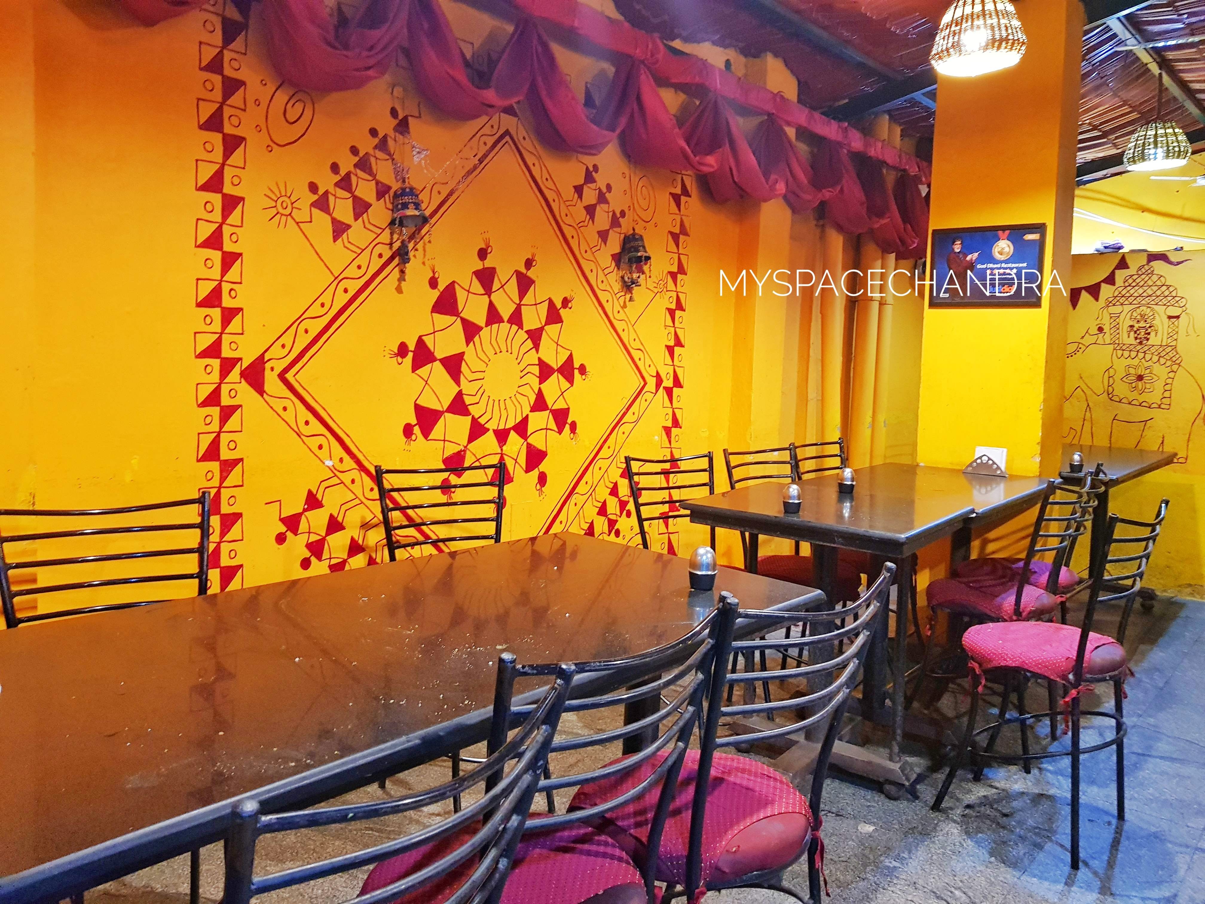 Yellow,Wall,Restaurant,Interior design,Room,Building,Architecture,Fast food restaurant,Furniture,Table