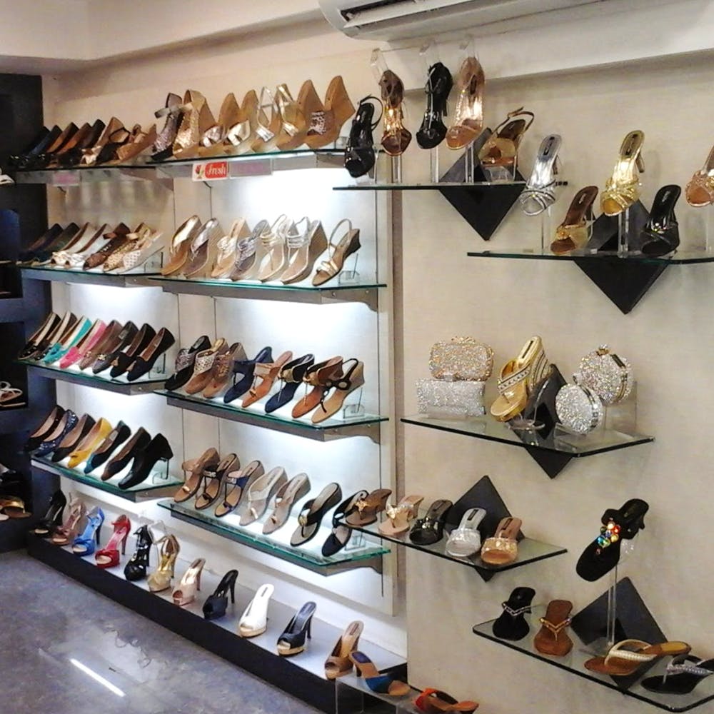 Shoe store,Footwear,Shoe,Collection,Shelf,Retail,Display case,Shelving,Shoe organizer,Furniture