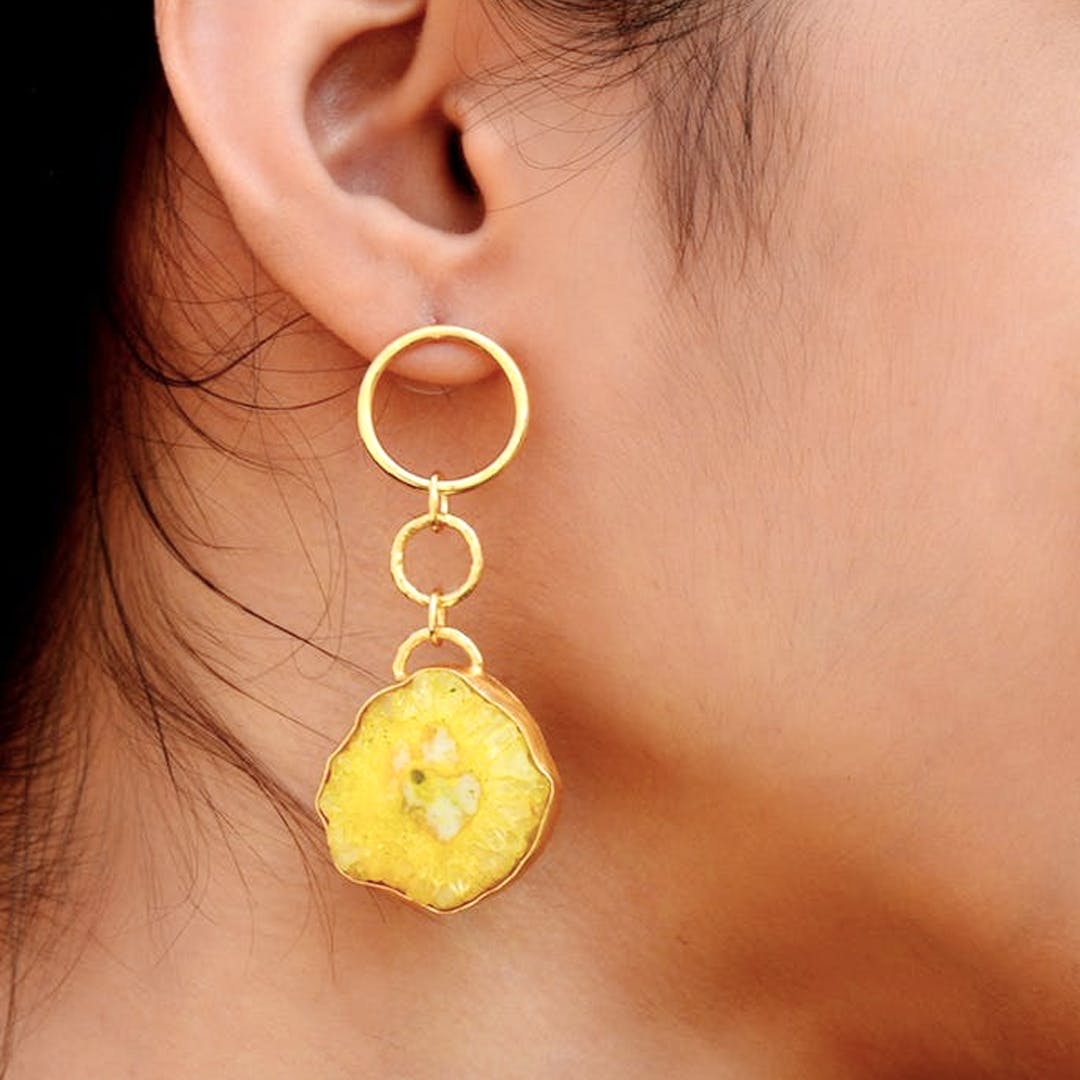 Yellow,Ear,Earrings,Jewellery,Fashion accessory,Chin,Organ,Body jewelry,Neck,Circle