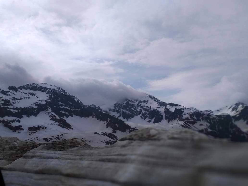 Mountainous landforms,Mountain,Sky,Mountain range,Highland,Cloud,Atmospheric phenomenon,Wilderness,Alps,Ridge