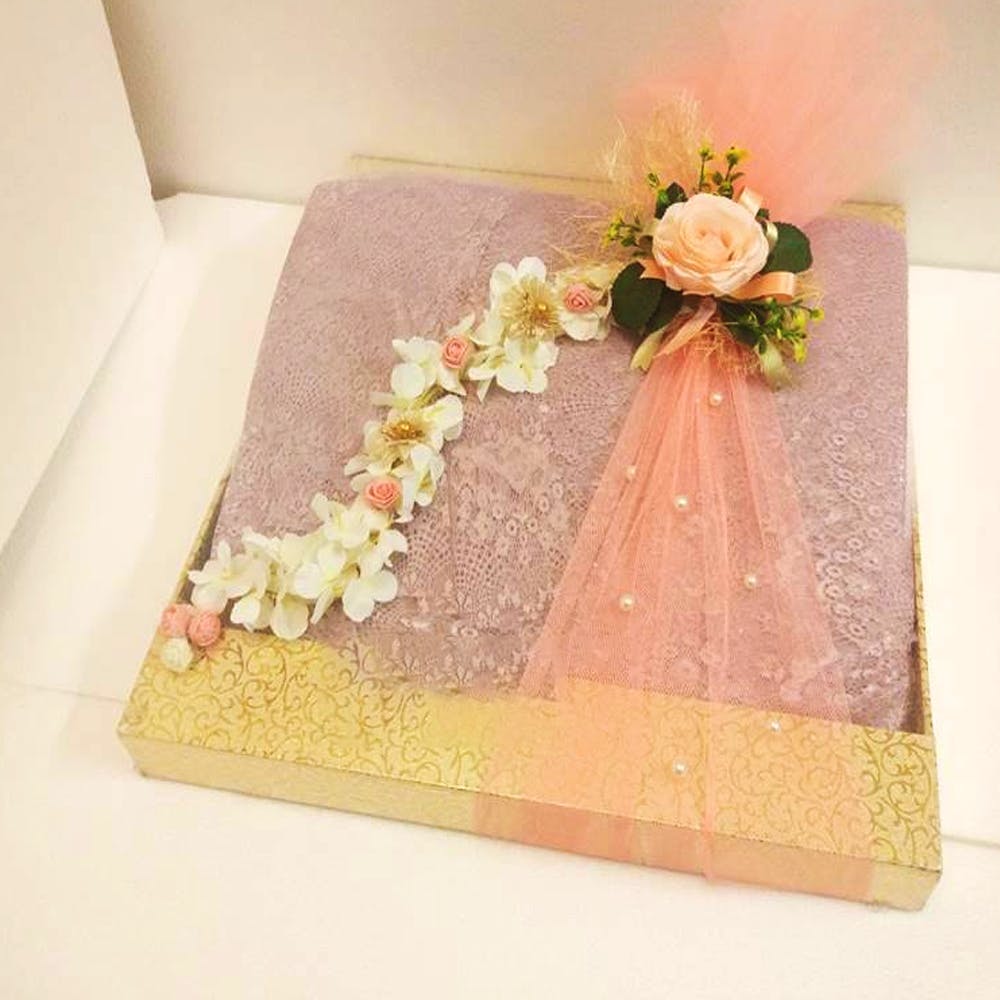 Pink,Cake,Flower,Wedding ceremony supply,Textile,Floral design,Plant,Floristry,Rectangle,Flower Arranging
