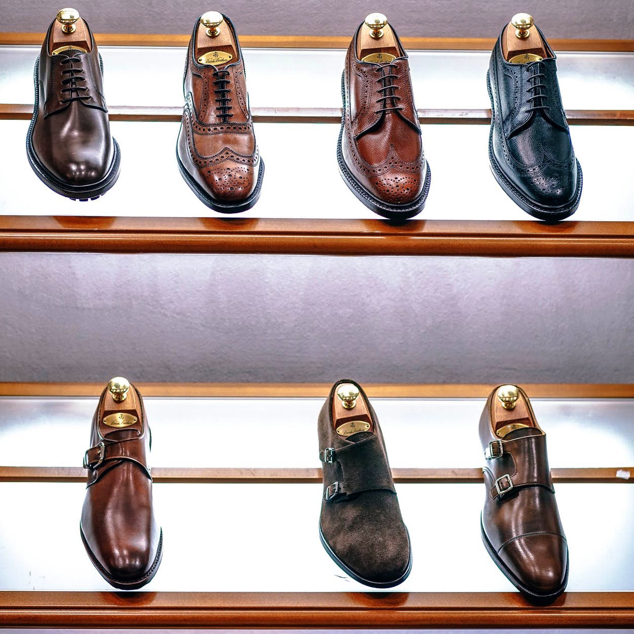 Footwear,Shoe,Brown,Shoe store,Dress shoe,Shelf,Metal,Leather,Ballet flat,Collection