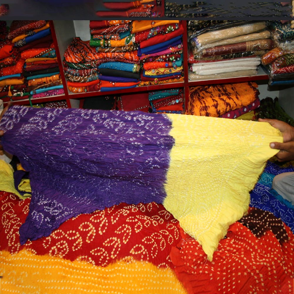 Textile,Orange,Bed sheet,Room,Linens,Furniture,Pattern,Thread,Knitting