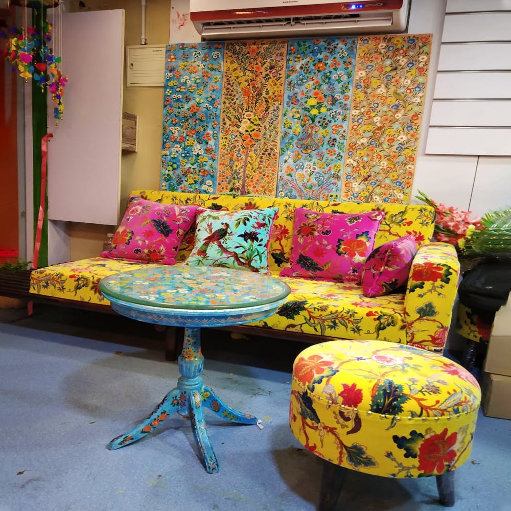 Furniture,Room,Couch,Chair,Yellow,Interior design,Table,Textile,Living room,Floral design