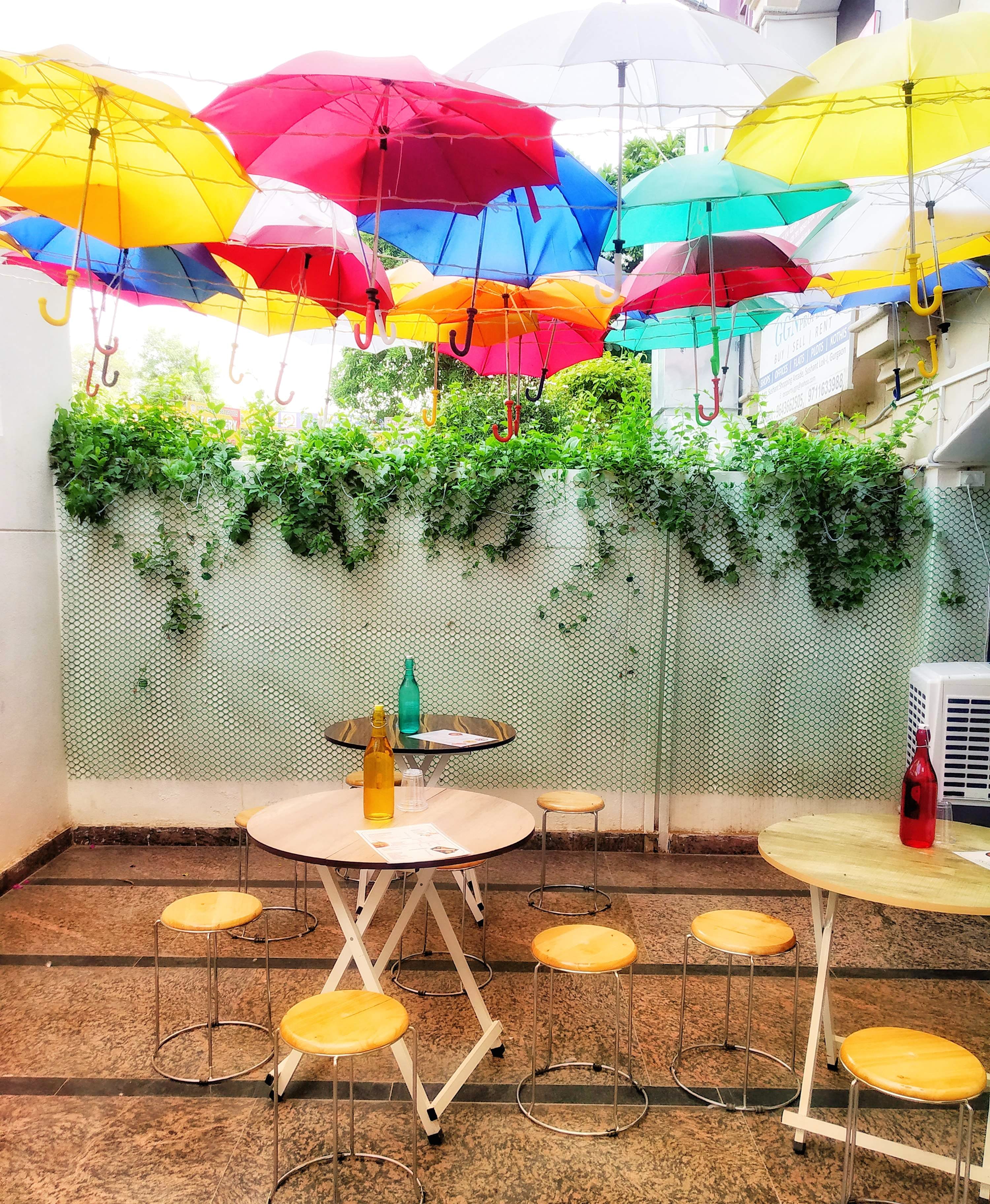 Umbrella,Yellow,Table,Furniture,Turquoise,Fashion accessory,Chair,Patio,Interior design,Plant