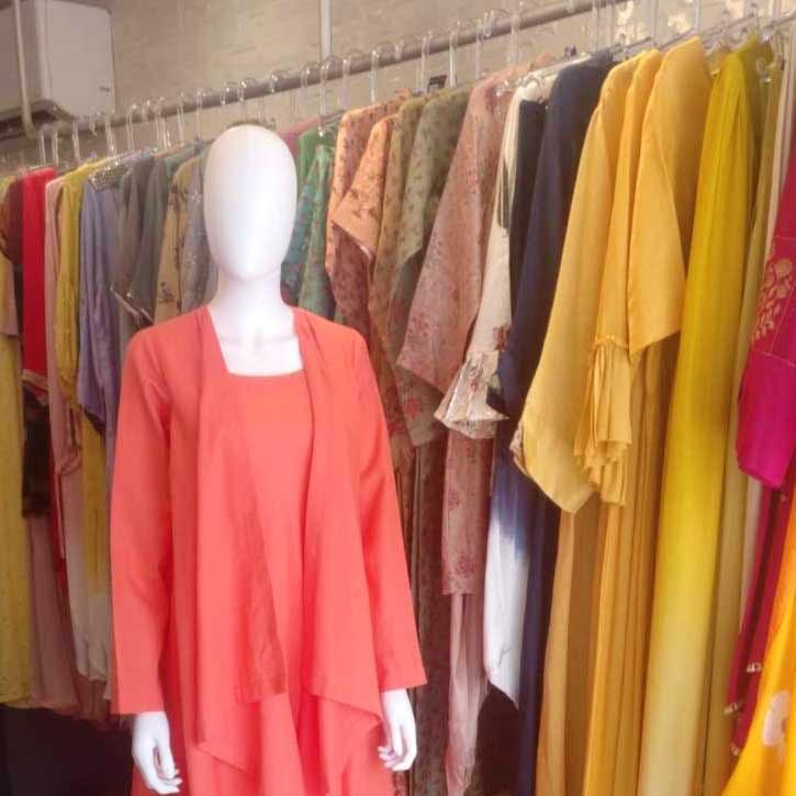 Boutique,Clothing,Clothes hanger,Yellow,Room,Outerwear,Pink,Fashion,Closet,Dress