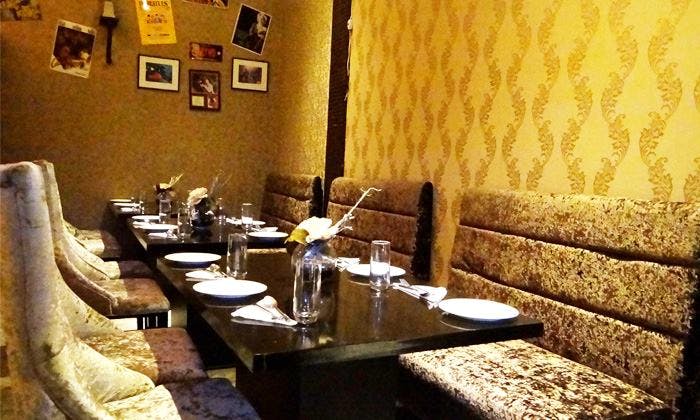 Room,Restaurant,Property,Interior design,Wall,Yellow,Table,Furniture,Building,Dining room