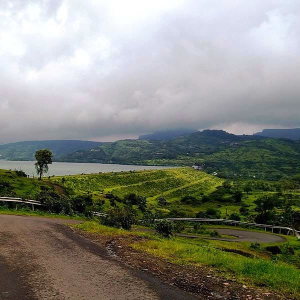 Highland,Sky,Mountainous landforms,Hill station,Hill,Road,Mountain,Atmospheric phenomenon,Natural landscape,Cloud