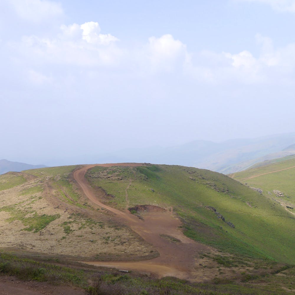 Highland,Mountainous landforms,Hill,Grassland,Plain,Ecoregion,Dirt road,Fell,Steppe,Soil