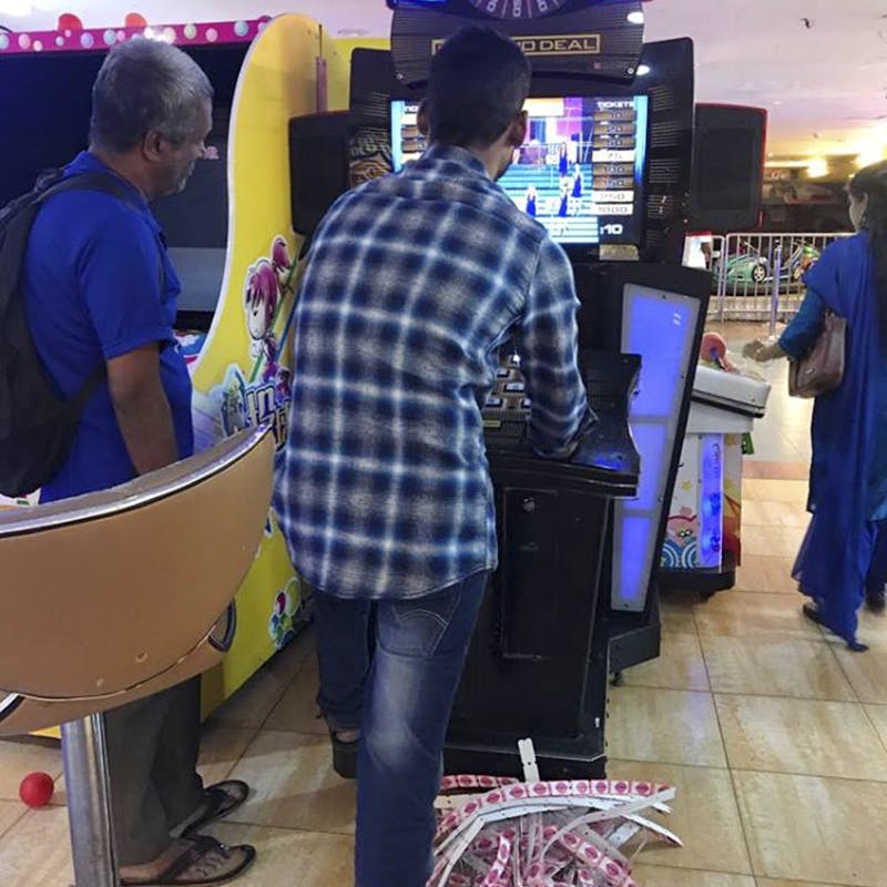 Games,Arcade game,Electronic device,Standing,Technology,Fun,Customer,Recreation,Video game arcade cabinet,Footwear