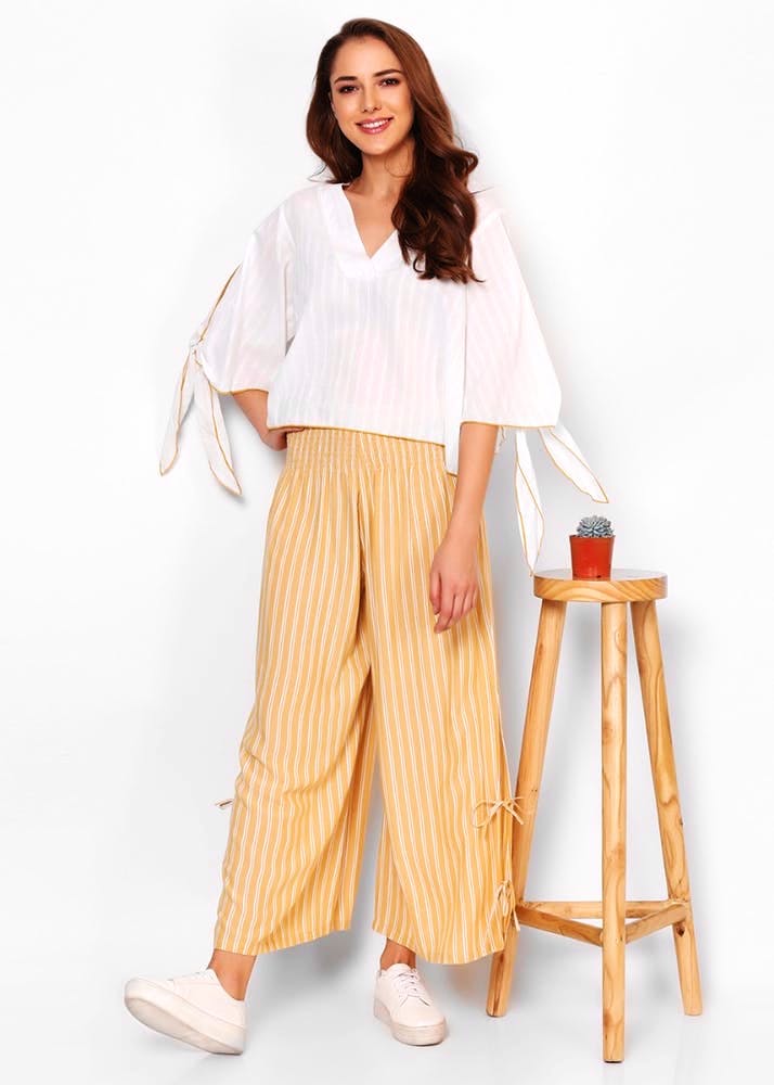 Clothing,White,Yellow,Leg,Waist,Trousers,Neck,Beige,Pattern,Pattern