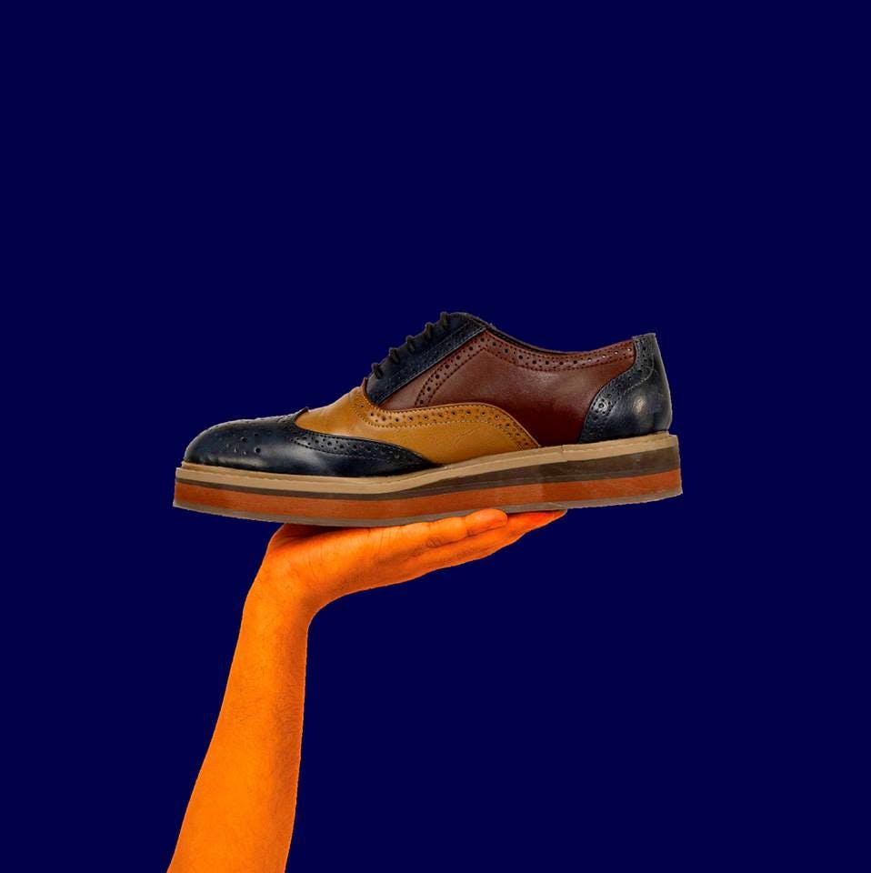 Footwear,Shoe,Blue,Orange,Brown,Tan,Electric blue,Sky,Still life photography,Outdoor shoe