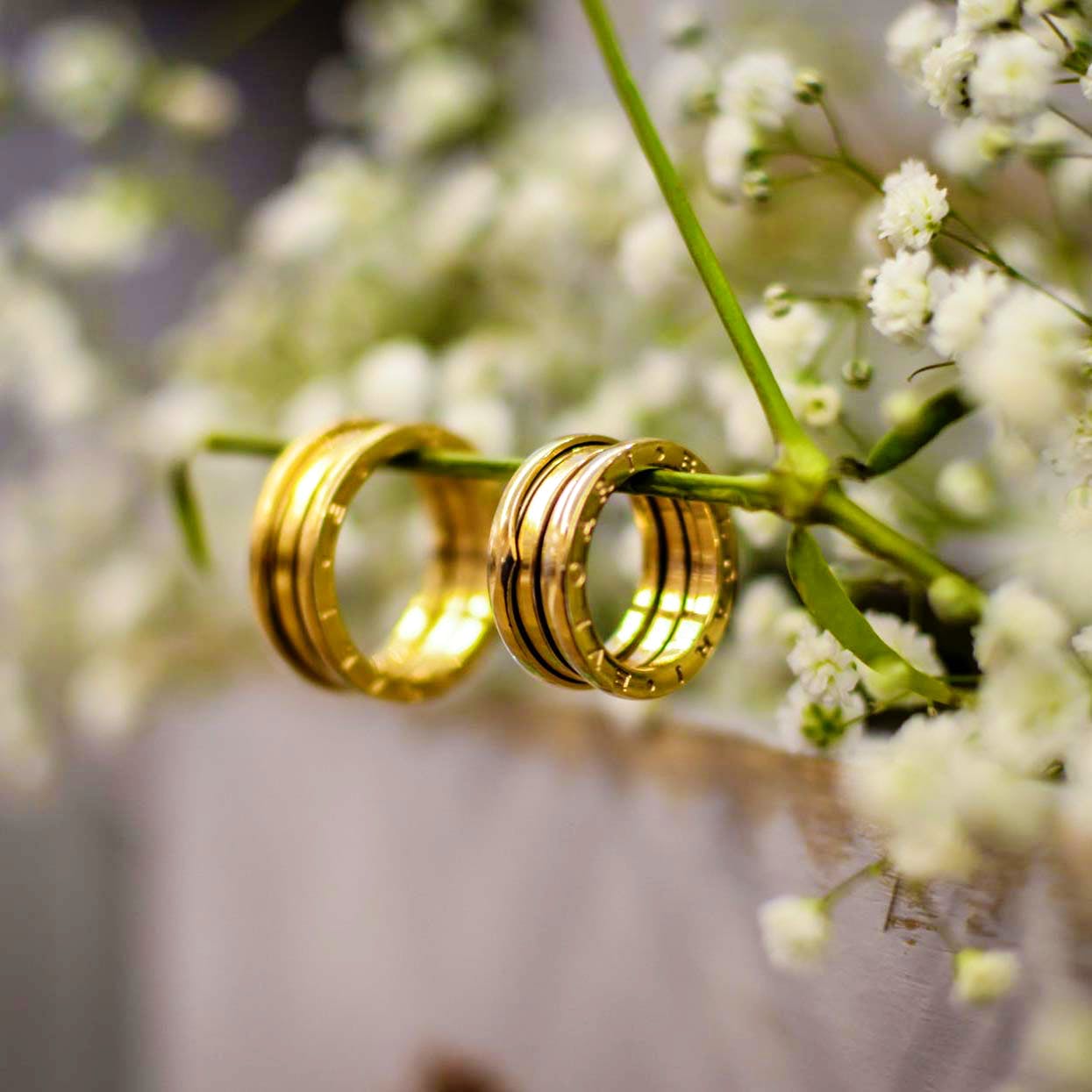 Yellow,Wedding ceremony supply,Flower,Plant,Spring,Metal,Wedding ring,Photography,Brass,Fashion accessory