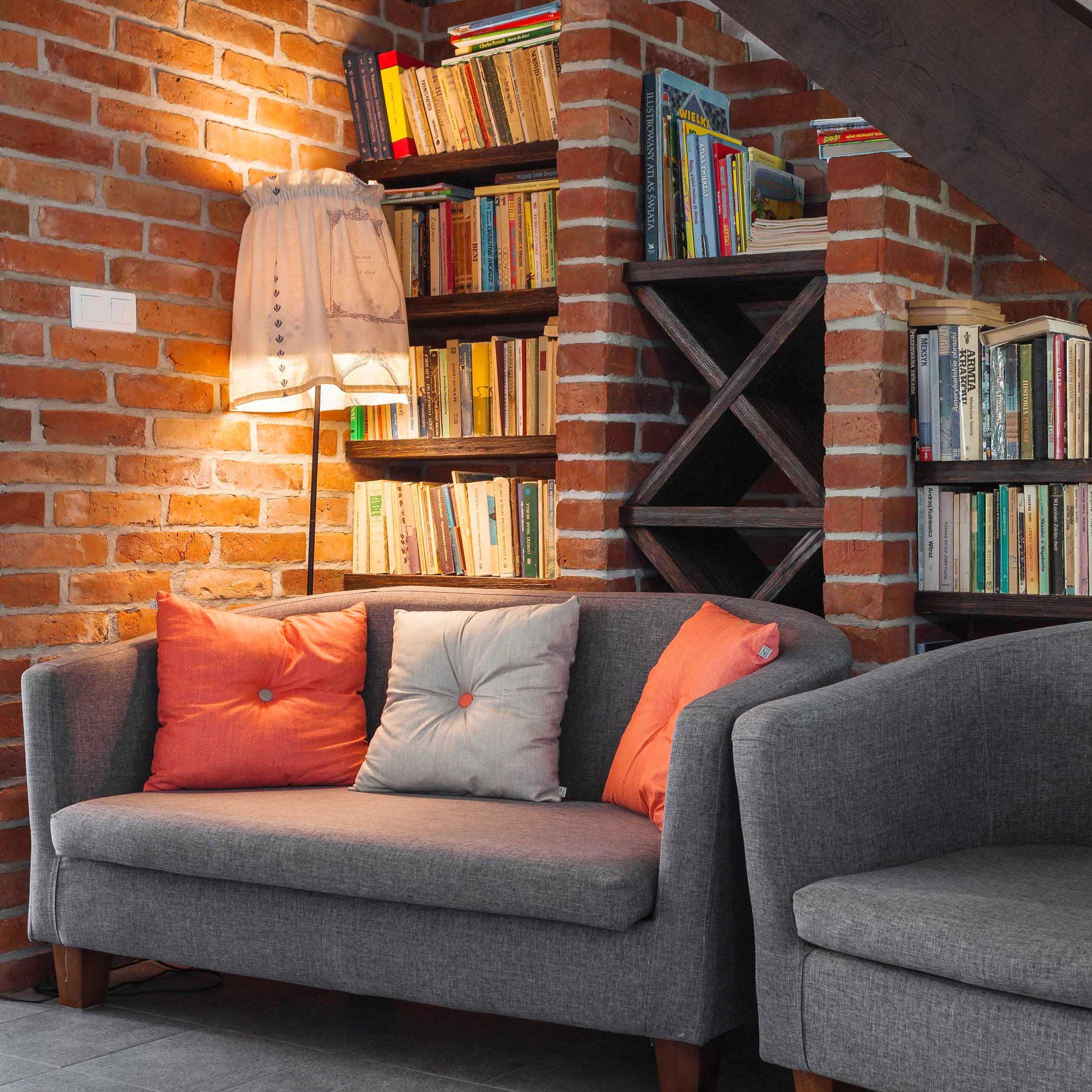 Furniture,Living room,Couch,Shelf,Room,Shelving,Wall,Orange,Bookcase,Interior design