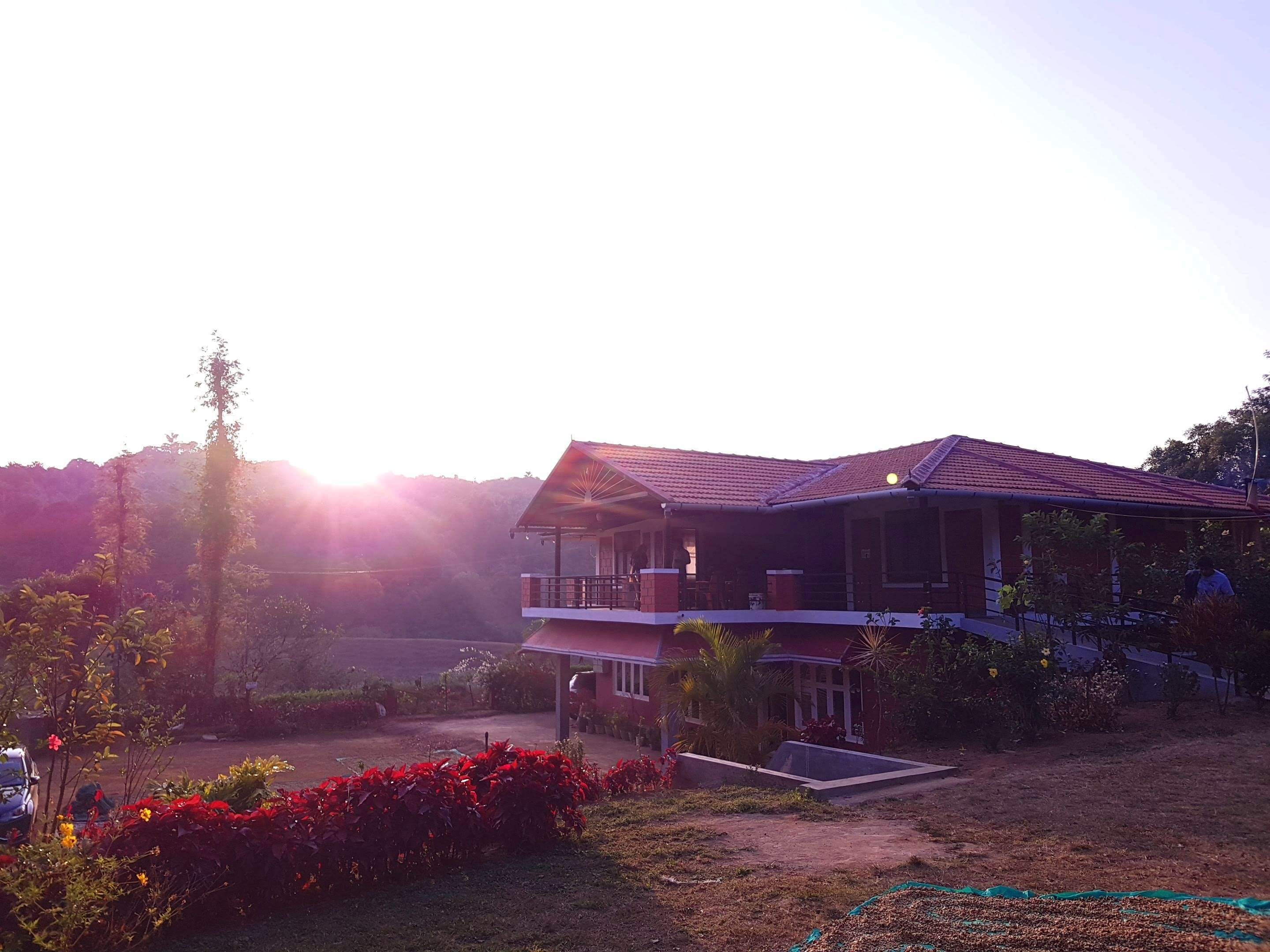 Sky,House,Atmospheric phenomenon,Home,Property,Morning,Tree,Hill station,Cloud,Pink