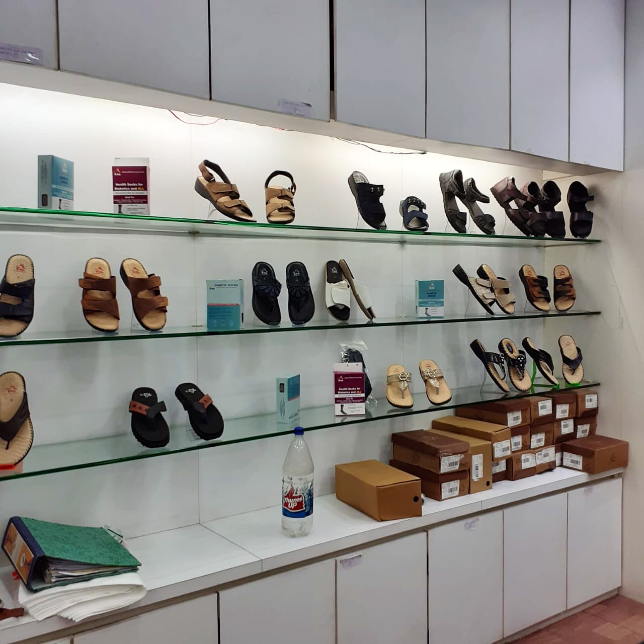 Shoe store,Footwear,Collection,Shoe,Display case,Building,Shelf,Room,Retail,Interior design