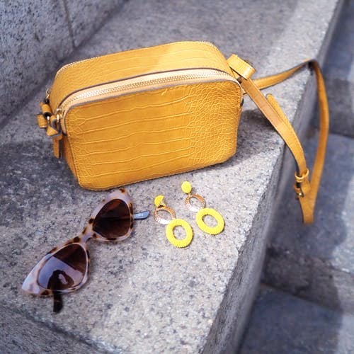 Eyewear,Glasses,Bag,Yellow,Leather,Fashion accessory,Sunglasses,Material property,Handbag,Beige