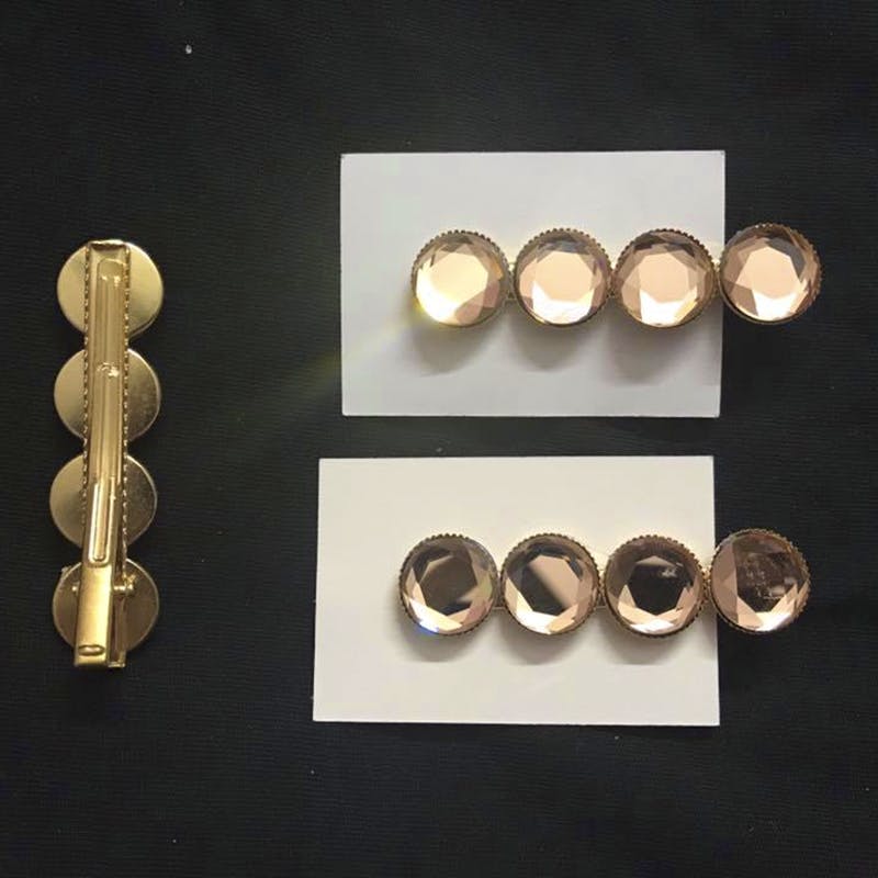 Brass,Metal,Font,Fashion accessory,Circle,Door handle,Copper,Button,Jewellery,Ear