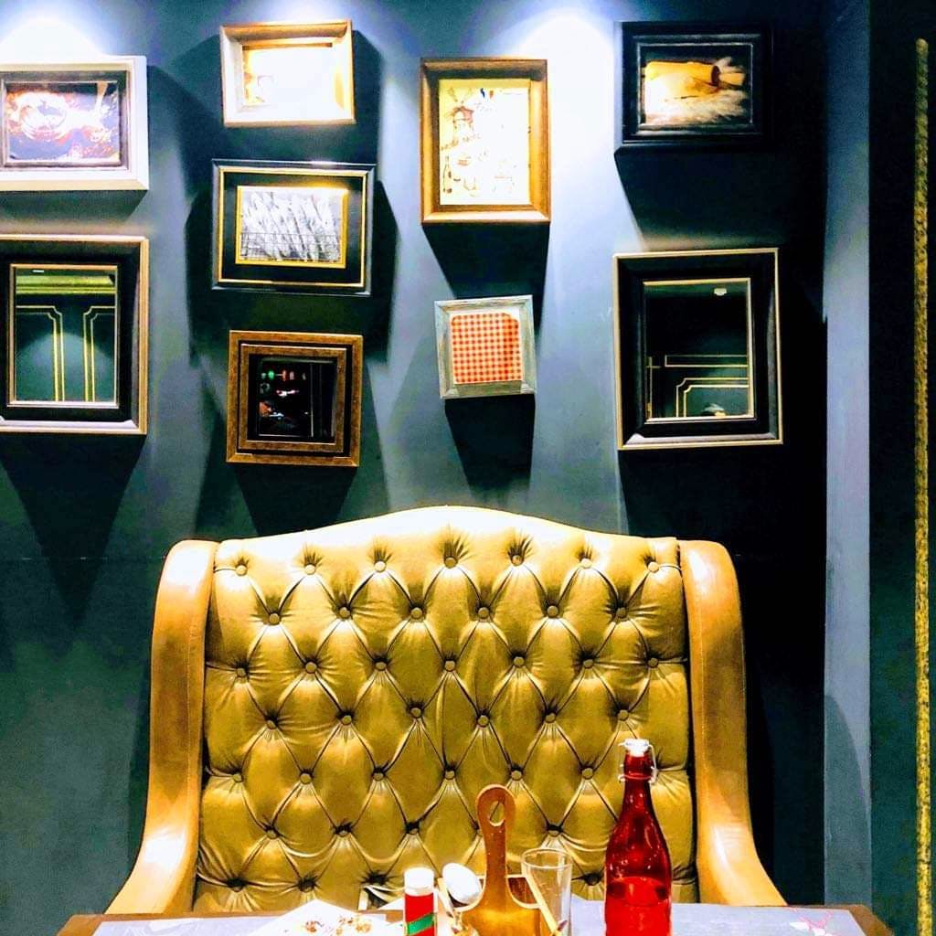 Room,Yellow,Interior design,Furniture,Table,Glass,Liqueur,Couch,Chair,Restaurant