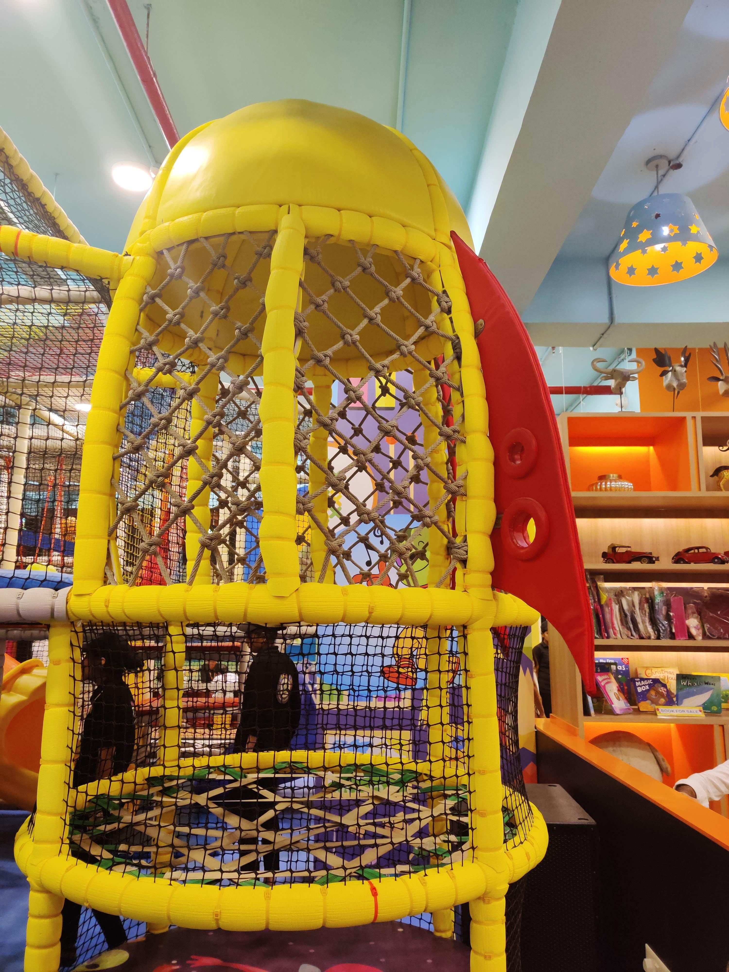 Cage,Yellow,Public space,Playground,Fun,Outdoor play equipment,Recreation,Supermarket,City,Play