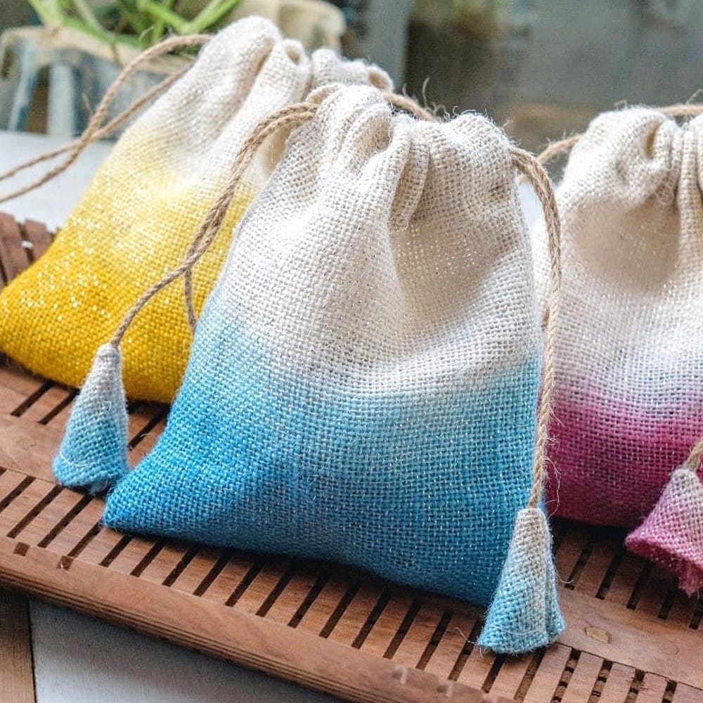 Yellow,Turquoise,Textile,Hand,Linens,Dishcloth,Wool,Pattern,Fashion accessory,Bag