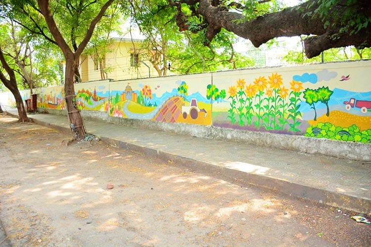 Wall,Street art,Graffiti,Yellow,Mural,Art,Tree,Urban area,Neighbourhood,Street