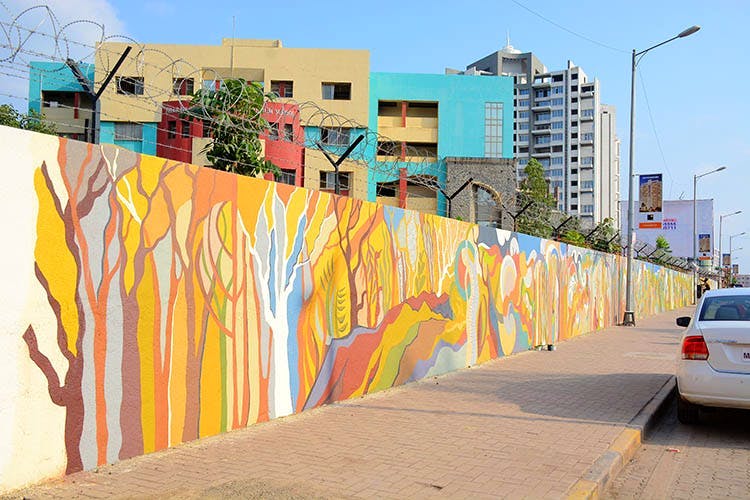 Neighbourhood,Wall,Yellow,Mural,Urban area,Town,Residential area,Art,Architecture,Street