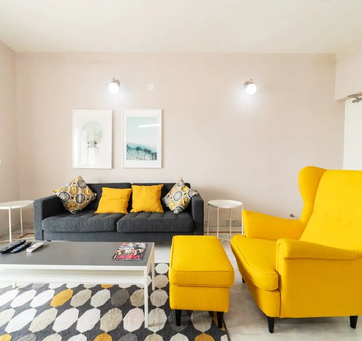 Living room,Furniture,Room,Yellow,Couch,Interior design,Property,Orange,Floor,Coffee table