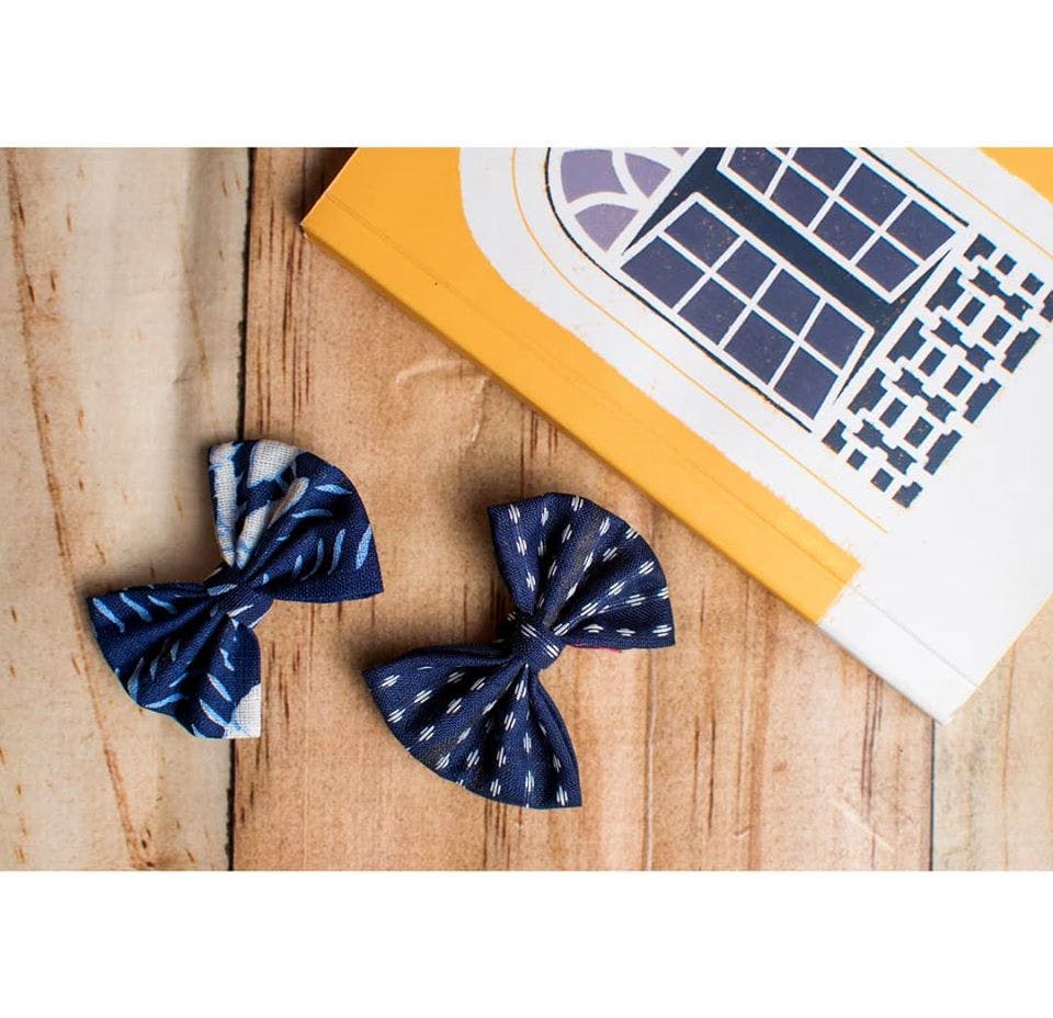 Blue,Bow tie,Tie,Yellow,Fashion accessory,Hair accessory,Pattern,Beige,Butterfly
