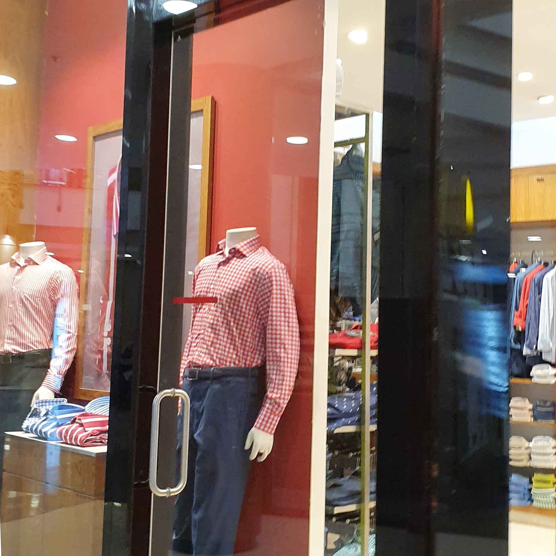 Boutique,Display window,Jeans,Display case,Retail,Textile,Shopping mall,Building,Door,Outlet store