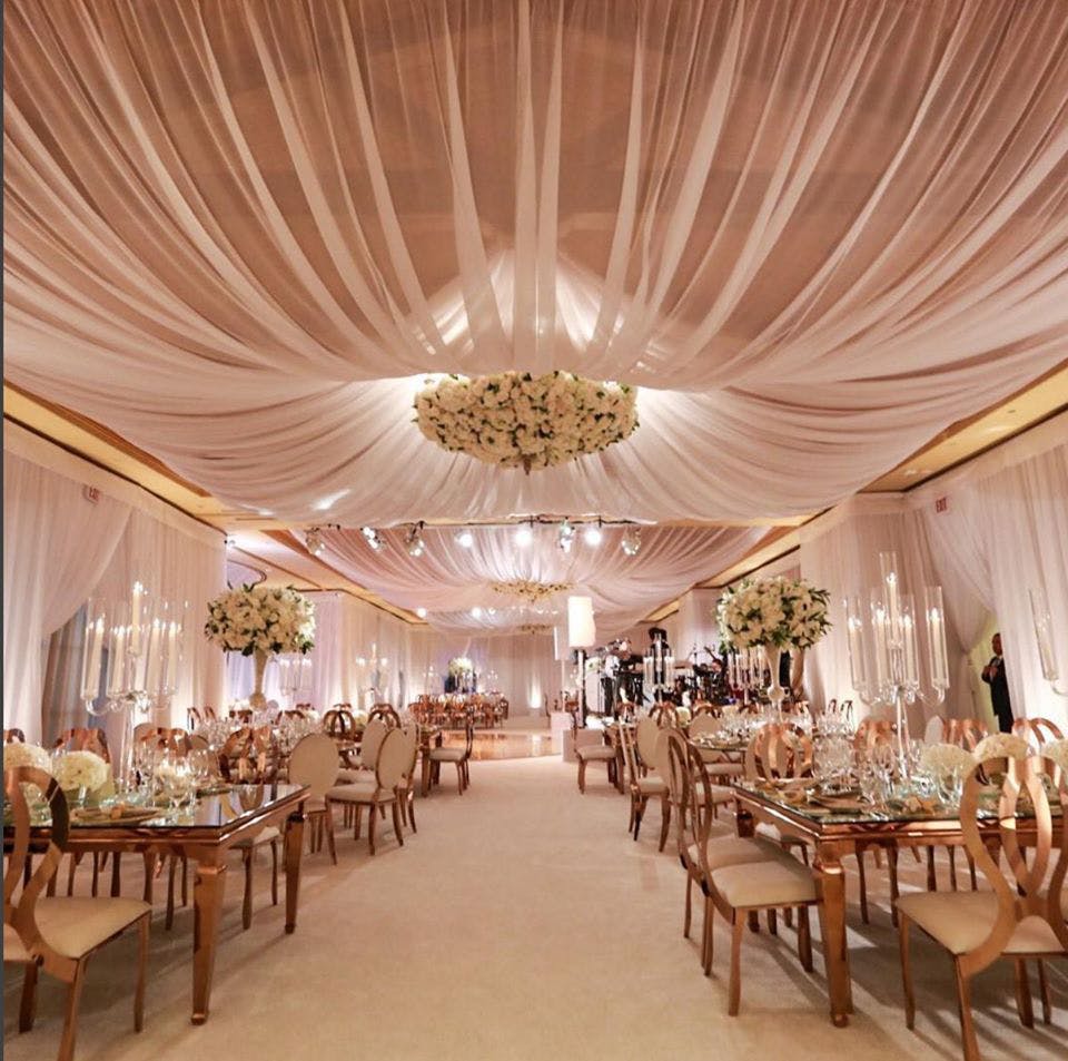 Decoration,Wedding banquet,Function hall,Chiavari chair,Ceiling,Ballroom,Interior design,Building,Lighting,Banquet