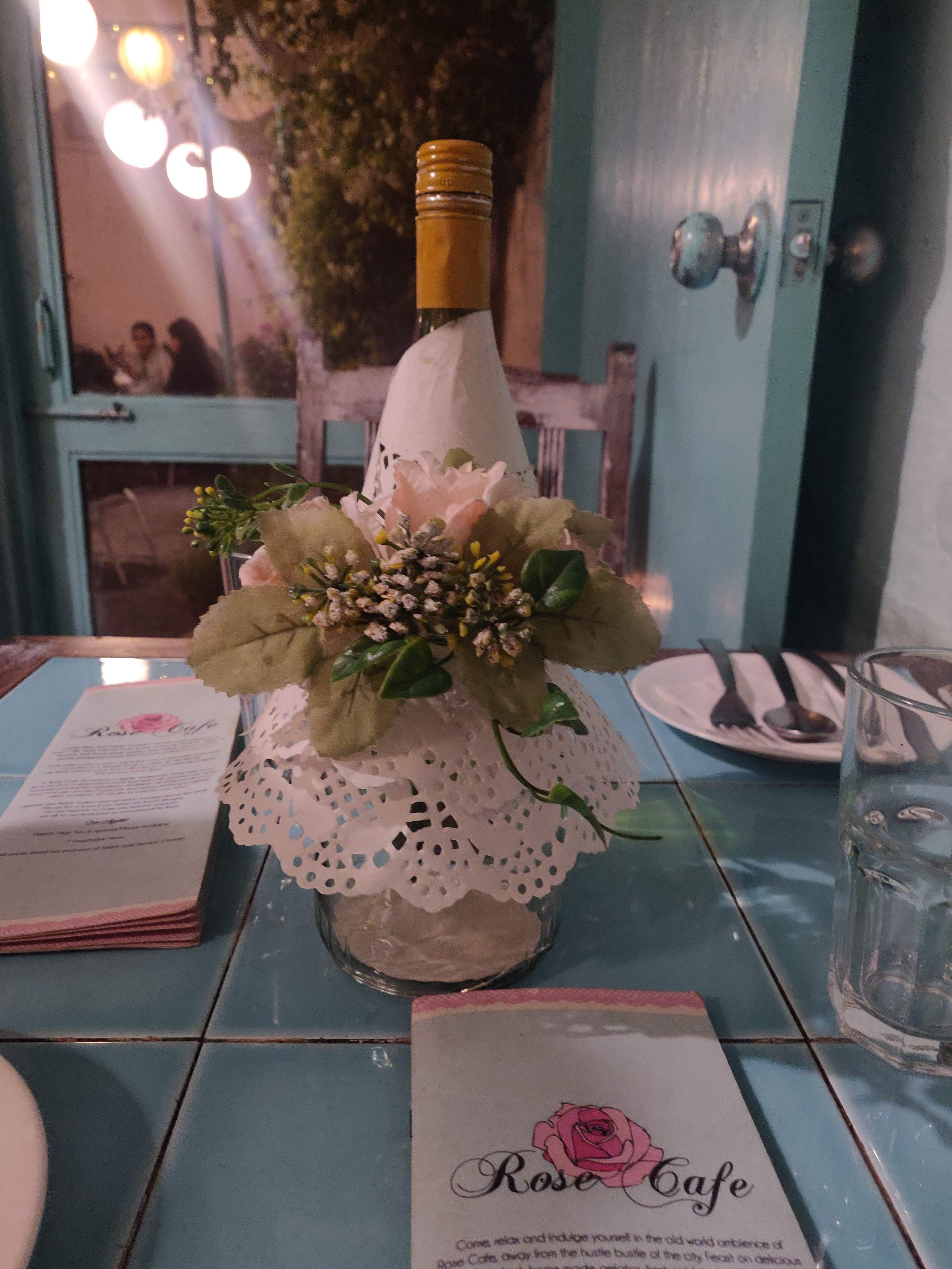 Centrepiece,Table,Flower,Glass bottle,Flower Arranging,Tablecloth,Linens,Plant,Bottle,Room