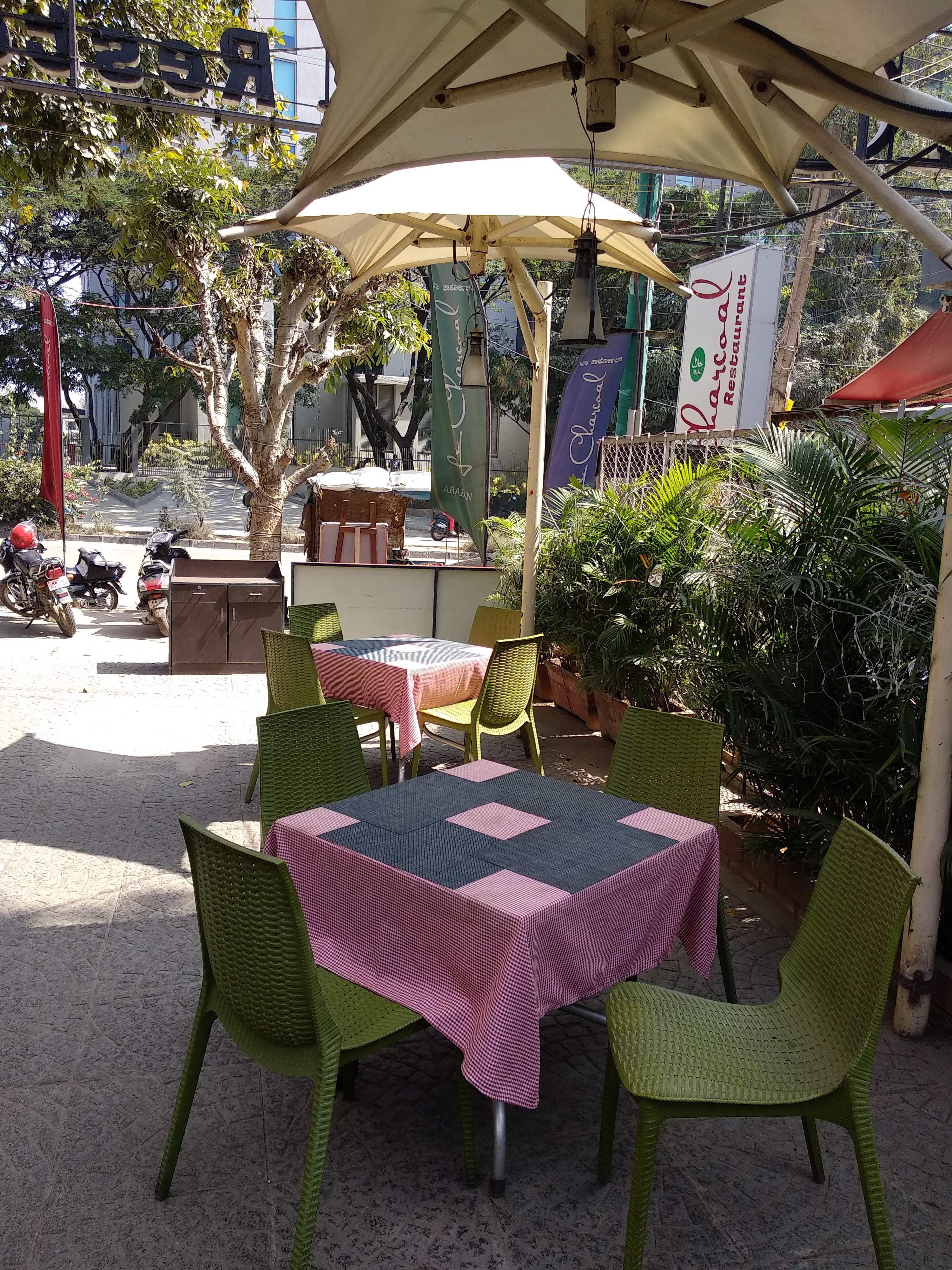Restaurant,Table,Property,Outdoor table,Furniture,Patio,Building,Tree,Chair,Tablecloth
