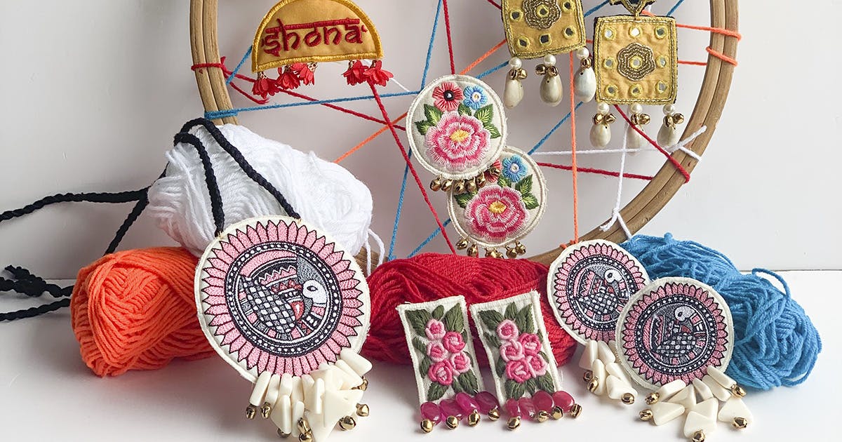 Textile,Embroidery,Room,Fashion accessory,Ornament,Crochet,Art,Furniture,Coin purse,Thread