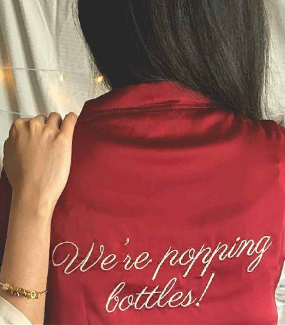 Red,Text,Shoulder,Neck,Font,Hand,Long hair,Sleeve