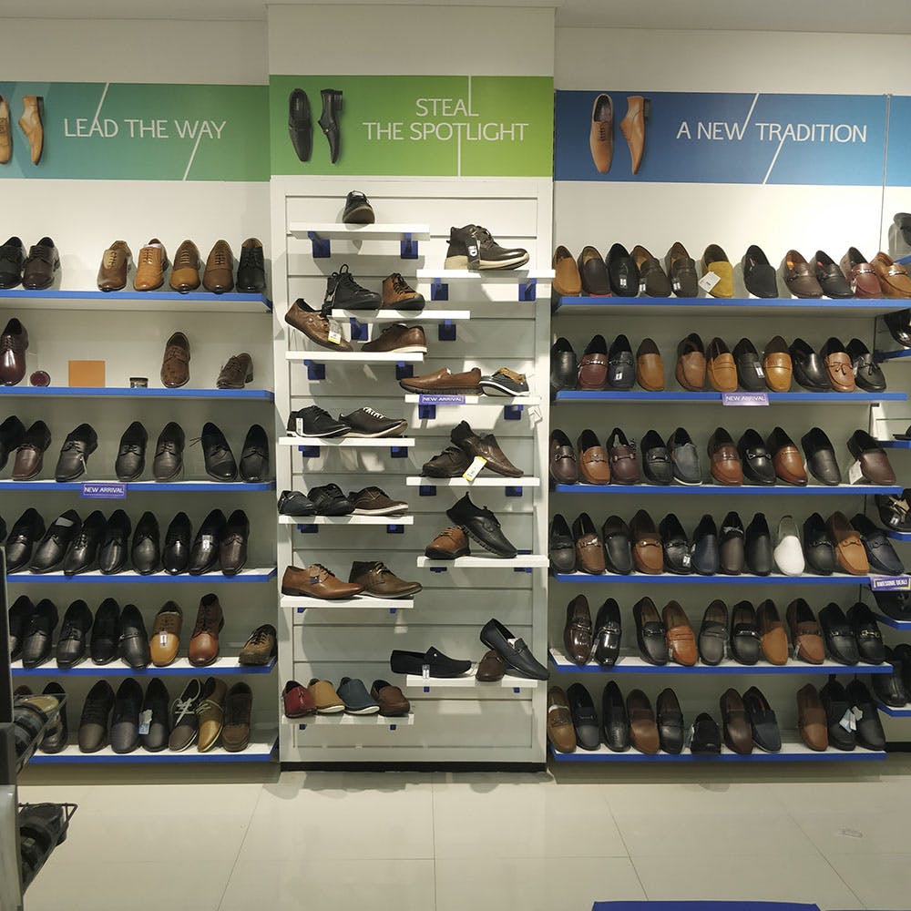 Shoe store,Footwear,Shoe,Outlet store,Building,Furniture,Shelf,Collection