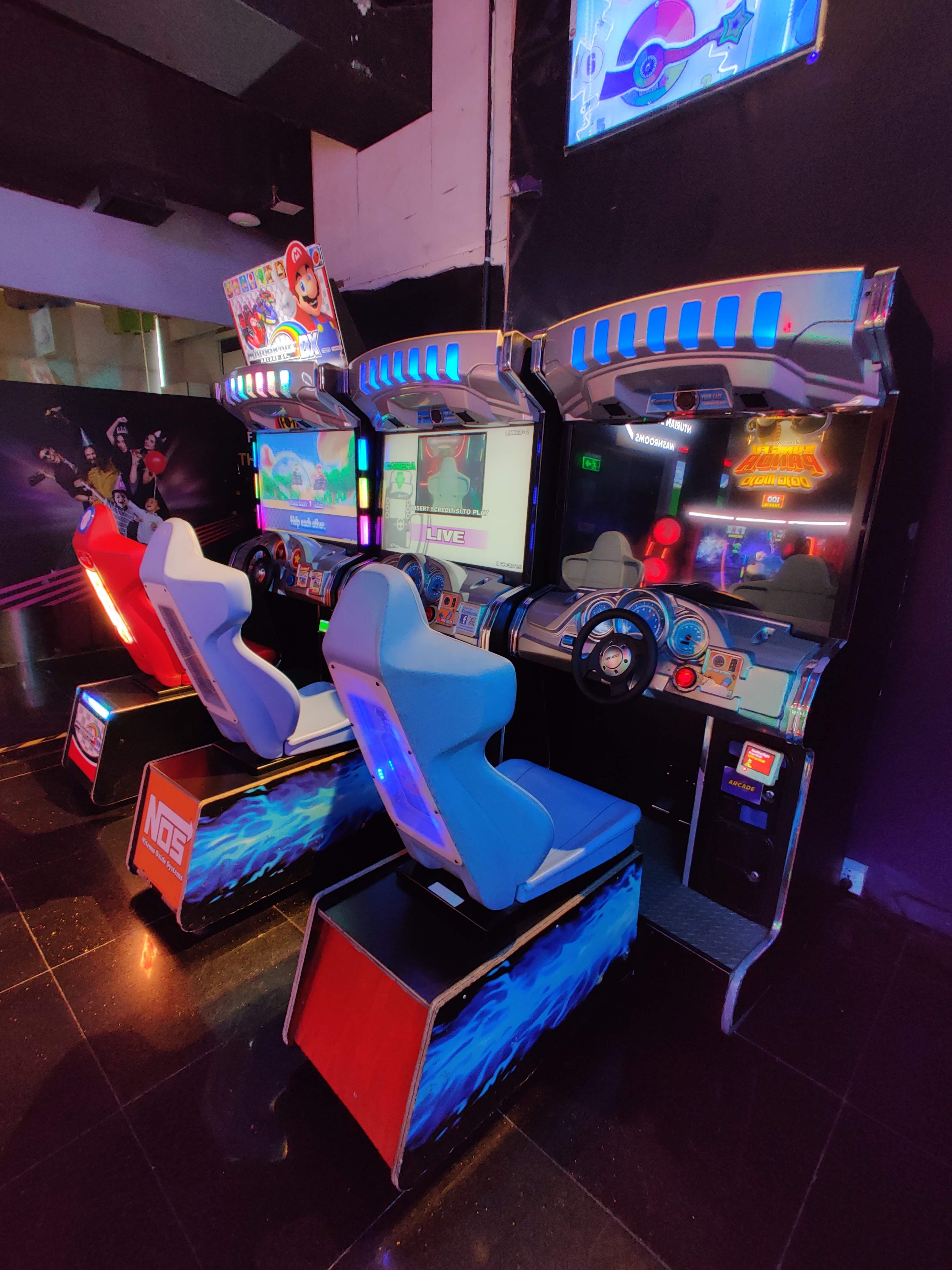Games,Arcade game,Technology,Recreation,Recreation room,Electronic device,Visual effect lighting,Room,Video game arcade cabinet,Leisure