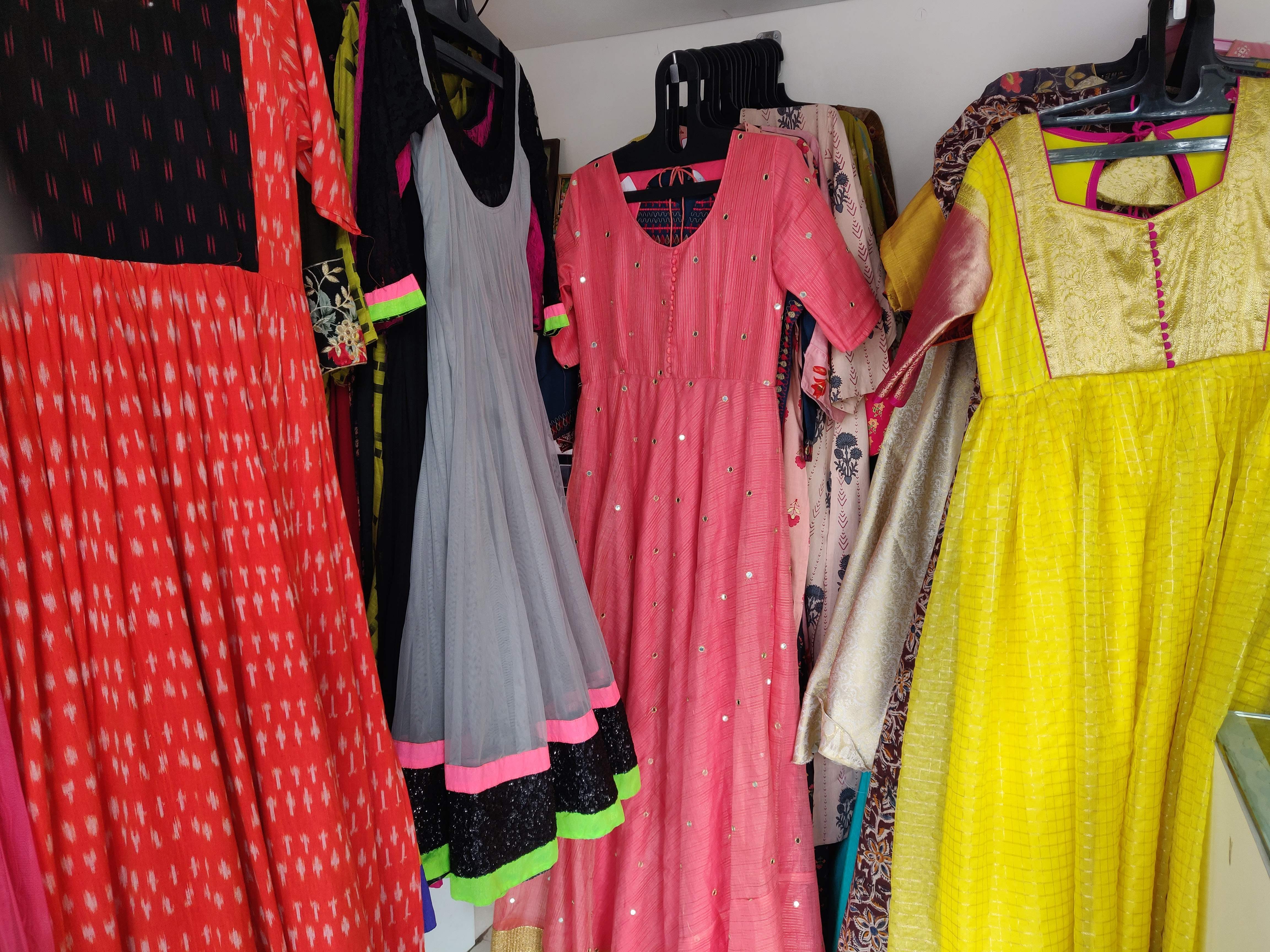 Clothing,Boutique,Pink,Dress,Yellow,Room,Formal wear,Fashion design,Textile,Magenta