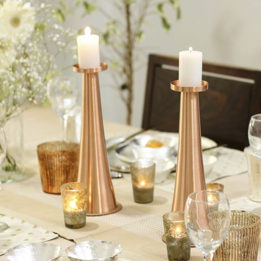 Candle holder,Lighting,Candle,Brass,Table,Interior design,Metal,Interior design,Glass,Light fixture