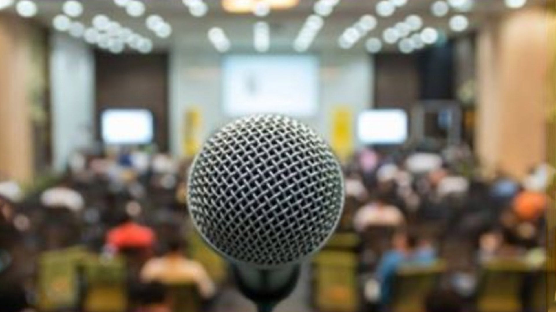 Microphone,Audio equipment,Public speaking,Technology,Electronic device,Crowd,Building,Audience