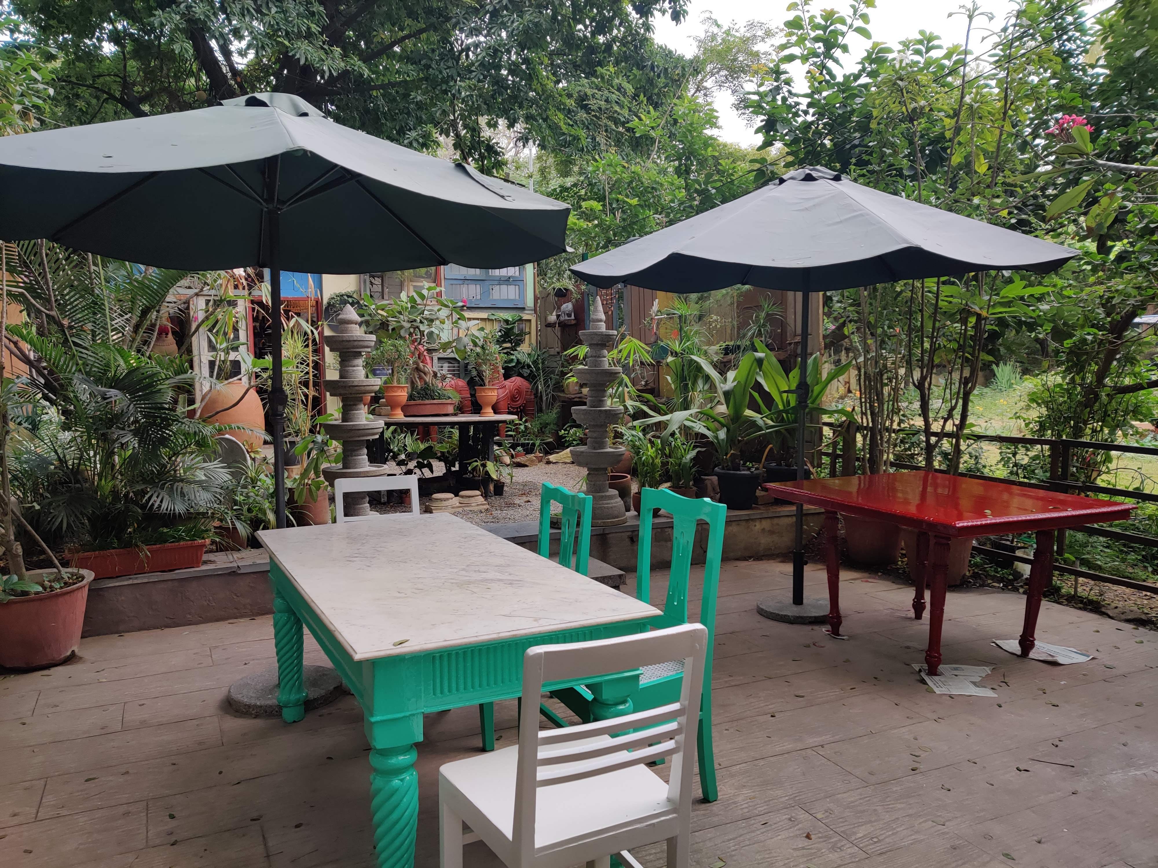 Outdoor table,Furniture,Table,Outdoor furniture,Patio,Umbrella,Backyard,Shade,Pavilion,Leisure
