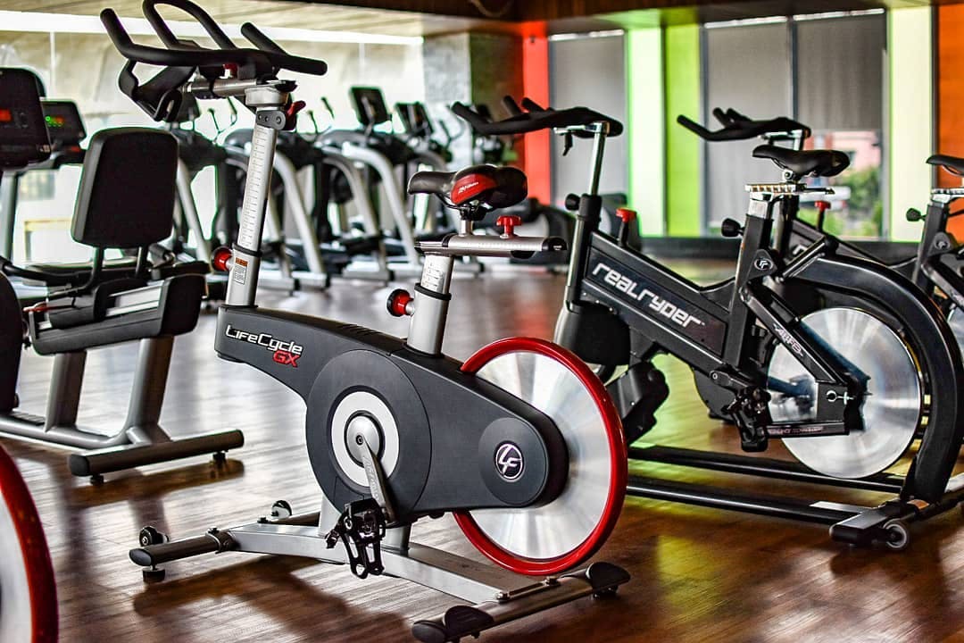 Indoor cycling,Exercise machine,Exercise equipment,Gym,Stationary bicycle,Room,Sports equipment,Exercise,Bicycle accessory,Vehicle