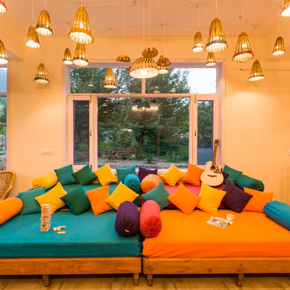 Room,Interior design,Yellow,Living room,Orange,Ceiling,Furniture,Turquoise,Lighting,Table